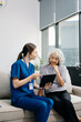 © Nuttapong punna - Doctors explain the use of medication to patients. Medical doctor holing senior patient's hands and comforting her on sofa