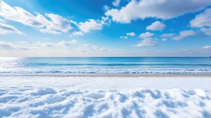 Wall Mural - Winter beach with snow-covered sand and a calm ocean, ample space for copy