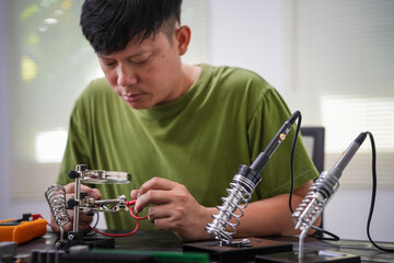 Engineer, a precise computer motherboard repair technician, uses a screwdriver to change parts, focuses on technology maintenance, repairs electronic devices, and supports ideas.