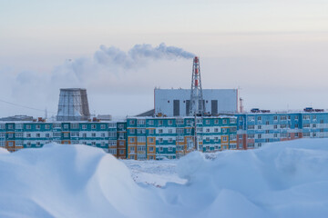 Wall Mural - View of residential buildings and the thermal power station of the northern city. Winter industrial landscape. Electric power industry in the Arctic. Cold weather. Anadyr, Chukotka, Siberia, Russia.