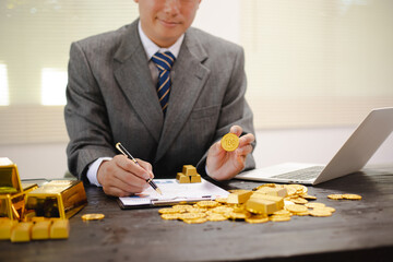 Businessman working hard with gold bars, assessing investments and transactions in finance office, wealth, asset allocation and precious metals trading strategies.