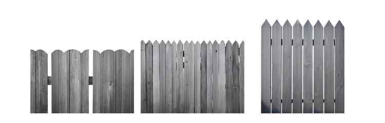 Poster - A gray wooden fence with pointed tops.  The fence is made of vertical slats of wood with some having knots.