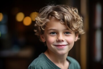 Poster - Portrait of a smiling little boy with curly hair in a restaurant