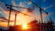 © Autchara - Silhouette of industrial cranes against a vibrant sunset sky, casting long shadows over a bustling construction site
