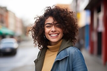 Poster - Portrait of a happy young woman with curly hair smiling at the camera