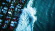 © Chopang.studio - Aerial view of vibrant coastal homes with waves crashing against the shore, creating a stunning beach landscape.