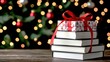 © chayantorn - A stack of books topped with a festive gift box, perfect for holiday gifting and cozy reading moments.