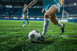 © Valeriia - Young soccer player feet running after the ball on green grass. Running female soccer football player. Female girl woman footballer kicking football match game.