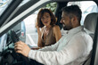 © Viacheslav Yakobchuk - Surprised woman holding contract looking at man in new car