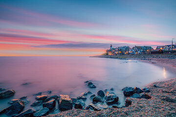 Sundown with lighthouse at historical village of Urk in the Netherlands alongside the lakeside coast of the IJsselmeer