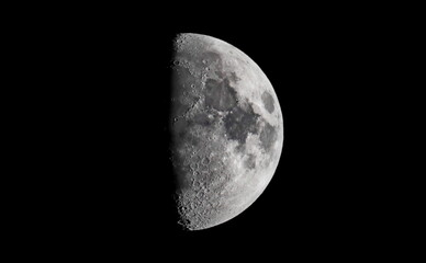 close up picture of waxing crescent moon in blue sky