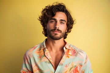 Canvas Print - A man with a beard and a floral shirt is smiling for the camera