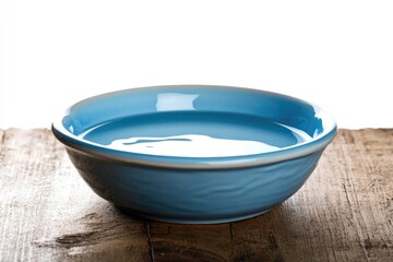 Poster - A blue bowl sits on top of a wooden table, ready for use