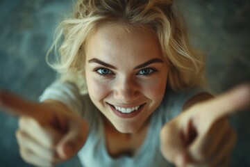 Aufkleber - A blonde woman points at the camera in this portrait image