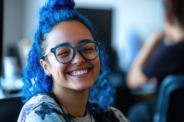 A young woman with blue hair and glasses smiling, potentially used for illustrations or characters