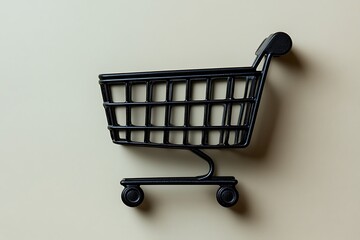 A miniature black shopping cart on a beige background. Ideal for Black Friday.