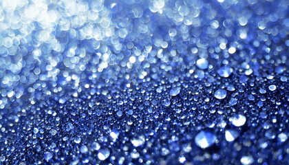 Poster - Close-up view of shimmering water droplets on a blue surface under soft light creating a mesmerizing sparkling effect