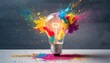 © netsay - A vibrant light bulb bursts with colorful powder, symbolizing creativity and innovation in a striking display of art