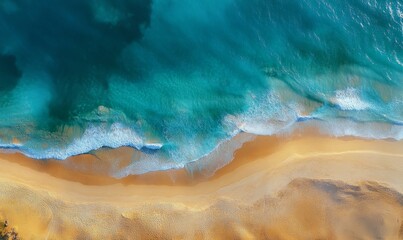 Clear turquoise water meets sandy beach under bright sunlight