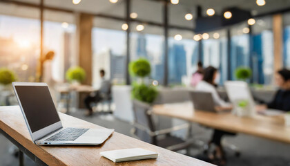 A modern office workspace with a laptop and a notepad during a busy afternoon in a city environment