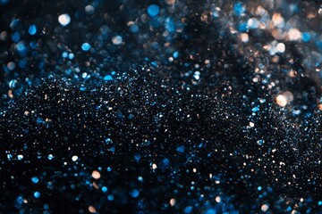 Dark glitter texture with bokeh lights and blue bokeh. Christmas and winter holiday background.