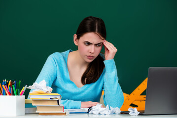 Thinking student in school. Pensive girl near blackboard. Student looking up deep thinking. Idea concept. College student learning in college classroom. Education concept. Lesson and homework in