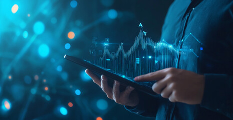 Aufkleber - A person uses a tablet to analyze a stock market graph, with an upward trend, glowing brightly against a blue and black background
