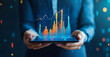 © PhotoArtHub - A person holds a tablet displaying a financial chart with an upward trend, symbolizing growth and success in business