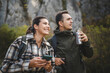 © Miljan Živković - portrait of adult couple hikers stand and use mobile phone
