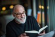 © Road Red Runner - A man reading a book while sitting in a sunlit corner of his cozy living room