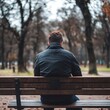 © SibteHUSSAIN - man experiencing disappointment and sadness sitting alone on a bench reflecting on emotions of loneliness and unhappiness in a moment of solitude