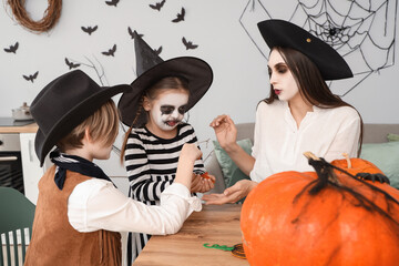 Wall Mural - Happy family celebrating Halloween at home