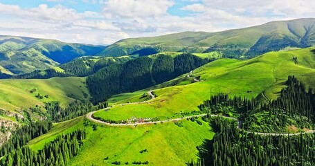 Wall Mural - Curved highway road and green grassland with mountain natural landscape in Xinjiang. Duku highway is the most beautiful highway in China.