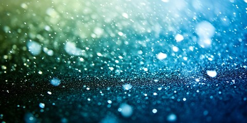 Abstract blue and green glitter background with bokeh effect, perfect for holiday or celebration design.