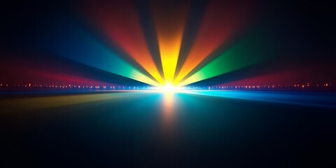 Abstract image of a rainbow light beam shining in the darkness.