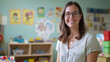 © Shanorsila - A cheerful daycare worker in a colorful classroom, looking at the camera with children’s art and toys in the background