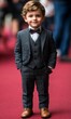 © jambulart - Young boy in suit and bow tie on red carpet.