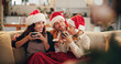 © Flashizzle/peopleimages.com - Christmas, family and happy on sofa with hot chocolate, coco and relax in home. Parents, child and eggnog in living room for comfort, warmth and enjoy festive season in winter with love and support