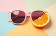 © Kseniya Ananko - Minimal style composition made of trendy sunglasses and slice of orange fruit on pastel geometric background