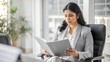 © Htet Wai Phyo - India  business lady boss serious reading about new project at modern office , folding hand and reading paper while sitting on chair,  lot of files on desk, copy space