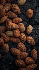 Wall Mural -  A pile of almonds atop black rocks One almond in each pile's center