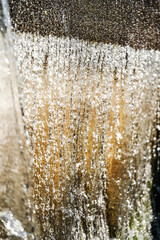 Wall Mural - water falling from a dam with many droplets. power and energy of water. dark concrete wall backgroun