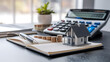 © Rsquare stock - tax day background,House model, house placed on a white surface, next to a calculator, a pencil, and some coins, symbolizing home finances, budgeting, or real estate planning.