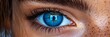© Viktor - A tight shot of a woman's blue eye, with the letter T inserted in her iris