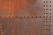 © Maxim Chuev - background of rust rivetin on metal brown wall backdrop. Grunge iron texture, industrial style background. texture pattern surface of rusty iron door sheet, iron rust