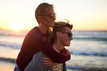 Wall Mural - Couple, piggyback and vacation at beach for sunset, relax and tropical holiday together with sunglasses. Man, woman and bonding by ocean for trip, romance and summer travel with weekend date in Ibiza