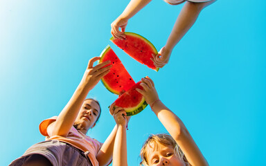 Children eat watermelon in summer. Selective focus.