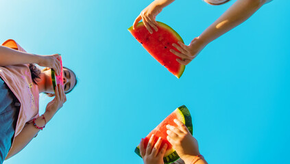 Poster - Children eat watermelon in summer. Selective focus.