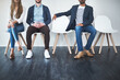 © Koegelenberg Coop/peopleimages.com - Group, job interview and row in waiting room, vacancy and recruitment for business and competition. Line, process and opportunity for applicant, chair and employment for people and onboarding
