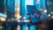 © aqiio - Hand holding a smartphone displaying a stock market graph in the middle of a bustling city at night.